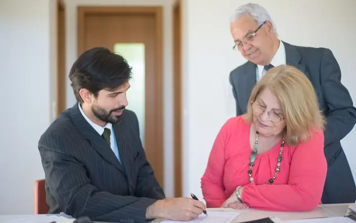 An estate agent going through documents with a couple